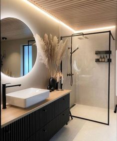 a bathroom with a sink, mirror and shower