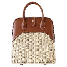 Mightychic offers a rare to find Limited Edition Hermes Picnic Bolide. Light weight wicker and the warmth of Barenia leather. The ultimate chic bag for any summer day - dress her up or down. Top has a beautifully braided edge. Front closure is the instantly recognizable palladium Clou De Selle. Handle base accented with flower knots. Comes with sleeper and signature Hermes box. NEW or NEVER WORN final sale mightychic offers an exquisite and unique array of Hermes. With a long and storied history Hermes Limited Edition, Hermes Bolide, Picnic Bag, Chic Bags, Hermes Handbags, Burberry Handbags, Basket Bag, Hermes Bags, One Bag