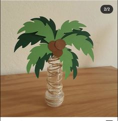 a paper palm tree in a bottle on a table