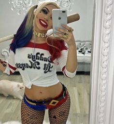 a woman taking a selfie in front of a mirror while wearing fishnet stockings