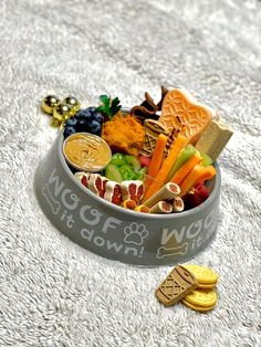 a bowl filled with lots of different types of food next to cookies and crackers