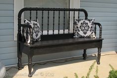 a black bench with two pillows on it