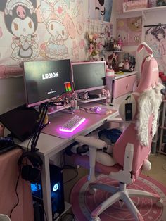 a desk with two computer monitors and a keyboard on it in a room decorated with hello kitty wallpaper