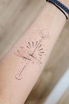 a woman's arm with a tattoo on it and an arrow in the middle