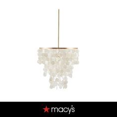 a chandelier with white beads hanging from it's side and the words macy's above it