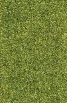 an area rug made out of green grass