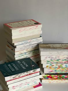 a stack of books sitting next to each other on top of a white countertop