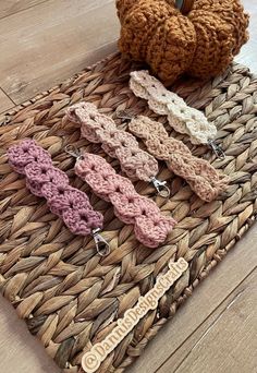 several crocheted hair clips on a woven mat