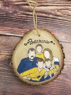 a wooden ornament with an image of three people on it