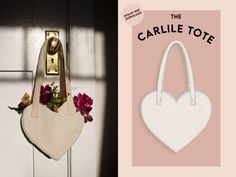 a white bag hanging on the side of a door with flowers in it and an advertise