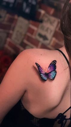 a woman with a butterfly tattoo on her shoulder