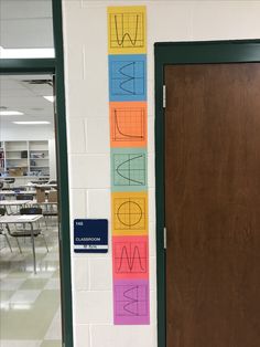 a classroom door decorated with colorful paper cutouts and school name stickers on it