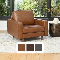 a brown leather chair sitting on top of a wooden floor next to a plant and window