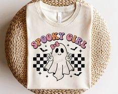 a spooky girl t - shirt on a wicker basket