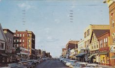 an old photo of cars parked on the street