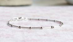 This cute dainty bracelet is handmade with silver-lined Japanese glass bugle beads, silver seed beads, and sterling silver findings (the heart charm is silver plated). The bracelet fastens with sterling silver lobster clasp. You can choose the length of your bracelet before putting it in the cart. More bracelets - https://www.etsy.com/shop/SentimentoShop?section_id=13605661&ref=shopsection_leftnav_2 Please contact me if you have any questions. Thank you for looking and have a great day! Please note: actual color shade may vary from picture due to computer settings. Minimalist Silver Bracelets With Tiny Beads, Minimalist Silver Beaded Bracelets For Everyday, Everyday Minimalist Bracelets With Spacer Beads, Minimalist Sterling Silver Bracelet With Spacer Beads, Dainty Silver Beads Bracelets For Jewelry Making, Dainty Everyday Nickel-free Beaded Bracelets, Minimalist Adjustable Chain Bracelet With Tiny Beads, Simple Handmade Silver Bracelets, Minimalist Handmade Silver Beaded Bracelets