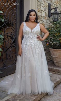 a woman in a wedding dress standing on steps