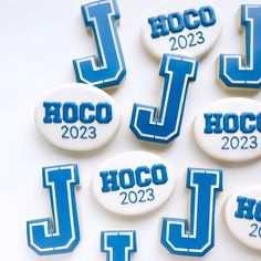 several buttons with the names of different sports teams on them, all decorated in blue and white