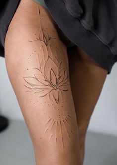 a woman's legs with tattoos on them, and the bottom part of her leg showing