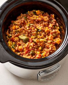 a crock pot filled with food sitting on top of a table