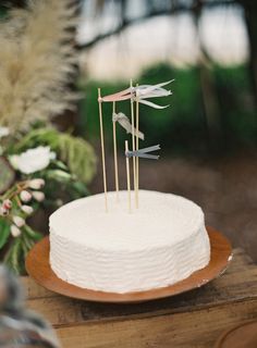 a white cake with three arrows on top