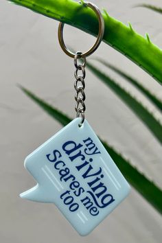 a keychain with the words stay wild on it hanging from a green plant