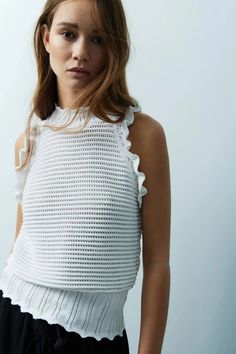 Get ready to turn heads with our Rana Sleeveless Sweater Tank! Its unique crochet halter top and delicate scallop detailing add a touch of whimsy to this versatile piece. The muted white hue effortlessly transitions from day to night, making it a must-have in your wardrobe. White Sleeveless Pointelle Knit Sweater, White Sleeveless Tank Top With Crochet Trim, White Sleeveless Crochet Trim Top, Sleeveless Pointelle Knit Tank Top For Beach, Summer Sleeveless Pointelle Knit Sweater Vest, Crochet Halter, Crochet Halter Tops, Fall Capsule Wardrobe, Sleeveless Sweater