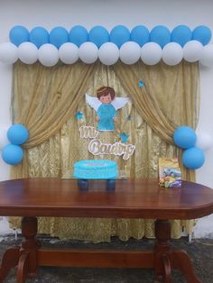 a table with a cake and balloons on it