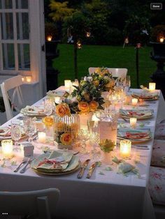 the table is set with candles and flowers