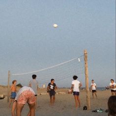 people are playing volleyball on the beach