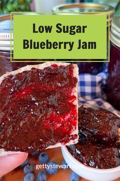 low sugar blueberry jam in a jar with a slice taken out and the text overlay reads low sugar blueberry jam