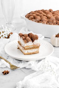 a piece of cake sitting on top of a white plate next to other desserts