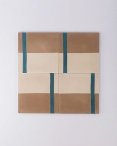 an abstract painting on the wall with blue and brown strips in it's center