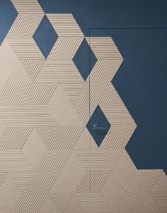 an abstract painting on the side of a building with blue walls and white geometric shapes