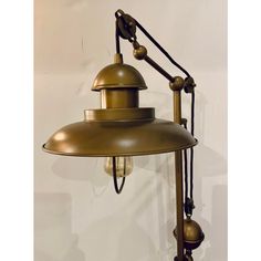 an antique brass wall light on a white background