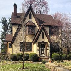 a house with brown shingles and white trim