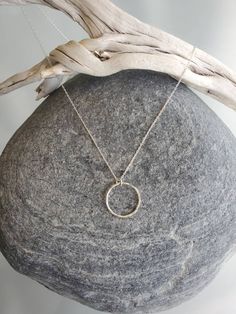 "This beautiful necklace has a handmade tiny sterling silver circle. Perfect to wear every day. The circle measures 10mm across and it hangs on a sterling silver chain with a sterling clasp. Shown in 17\" length, layered with our medium silver hammered bar necklace, available here: https://www.etsy.com/listing/506639121/sterling-silver-bar-necklace-medium?ref=shop_home_active_1 Also available in gold as shown in the last photo. *If you are unsure of the length you need, or would like to wear thi Sterling Silver Hammered Jewelry Gift, Hammered Sterling Silver Jewelry Gift, Hammered Sterling Silver Jewelry For Gifts, Silver Round Disc Necklaces For Everyday, Circular Jewelry With Adjustable Chain For Gift, Delicate Hammered Sterling Silver Jewelry, Everyday Circle Charm Necklaces With Adjustable Chain, Adjustable Full Circle Jewelry Gift, Minimalist Hypoallergenic Circular Jewelry