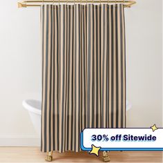 a shower curtain with black and white stripes on it, next to a bathtub