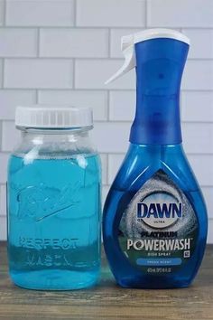 a bottle of dawn powerwash next to a jar of dish soap on a table