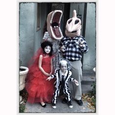 three people dressed up in costumes posing for a photo