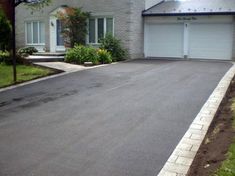 an empty driveway in front of a house