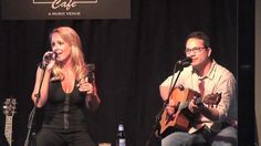 two people on stage with guitars and microphones