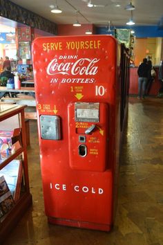 an old fashioned coca cola machine in a store