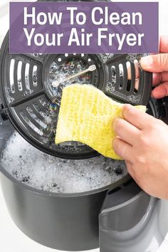 a person cleaning an air fryer with a sponge on it and the words, how to clean your air fryer