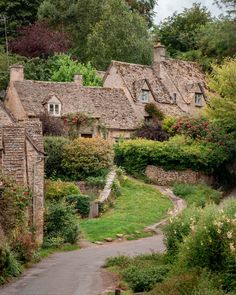 an old village with stone houses and flowers