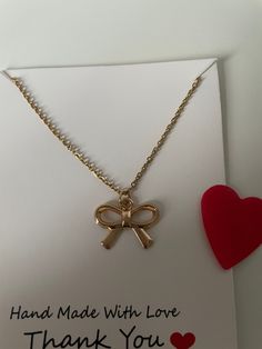 A beautiful bow necklace on an 44cm gold stainless steel chain size of bow is 1.6cm x 2.1 cm gold colour alloy charm