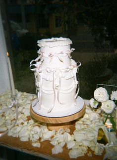 a white wedding cake sitting on top of a table