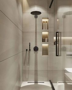 a bathroom with a shower head and hand held shower faucet in the corner