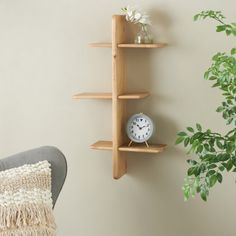 a wooden shelf sitting next to a plant on top of a wall in a living room