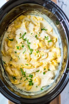 a crock pot filled with macaroni and cheese